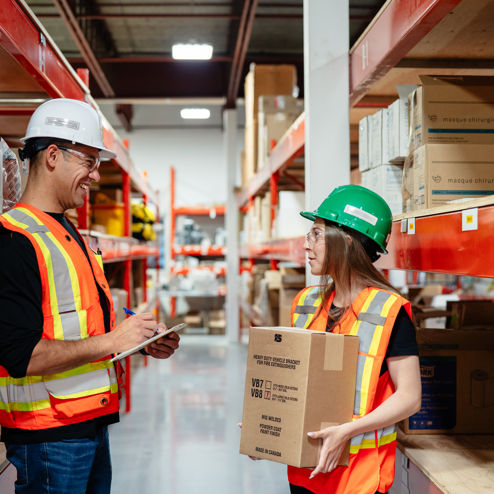 deux personnes parlent dans un entrepôt
